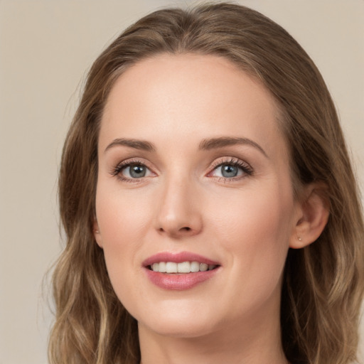 Joyful white young-adult female with long  brown hair and green eyes