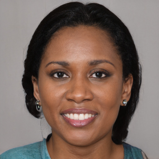 Joyful black young-adult female with medium  black hair and brown eyes
