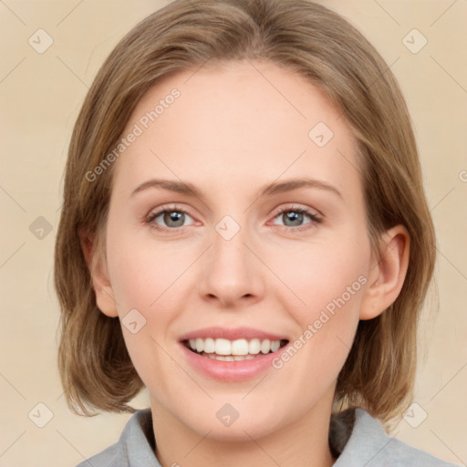 Joyful white young-adult female with medium  brown hair and green eyes