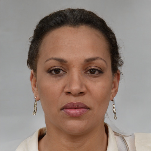 Joyful latino adult female with short  brown hair and brown eyes