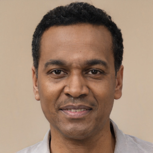Joyful latino adult male with short  black hair and brown eyes