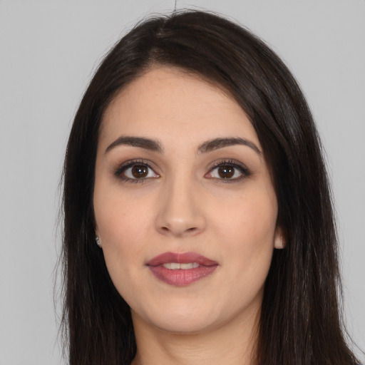 Joyful white young-adult female with long  black hair and brown eyes