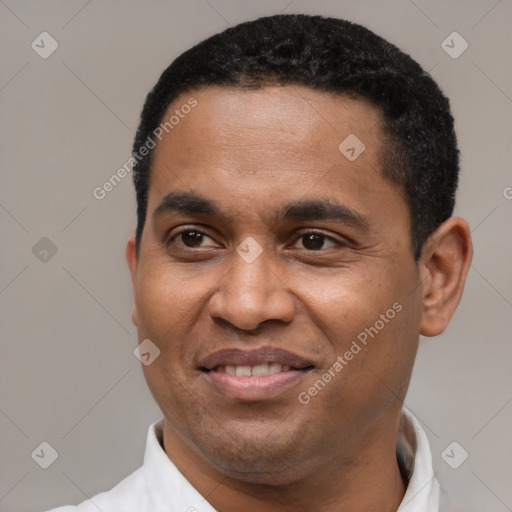 Joyful latino adult male with short  black hair and brown eyes