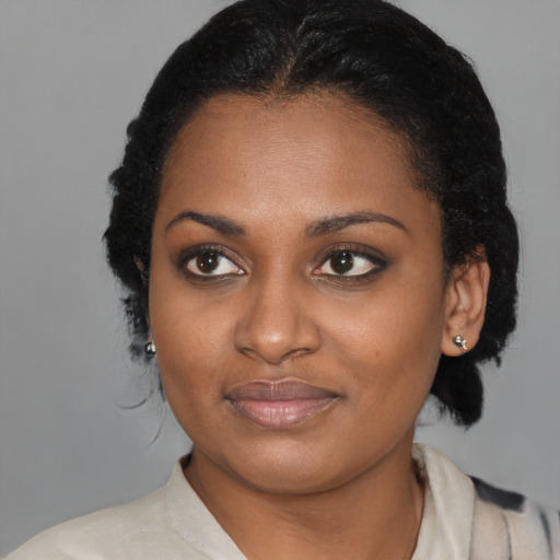 Joyful black young-adult female with medium  black hair and brown eyes
