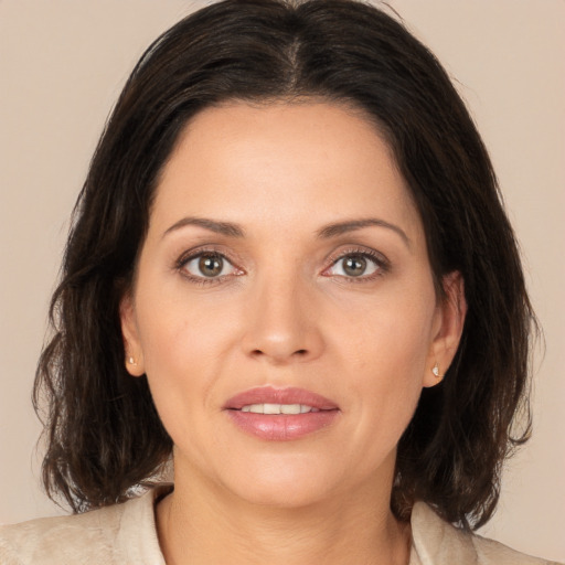 Joyful white young-adult female with medium  brown hair and brown eyes