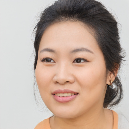Joyful asian young-adult female with medium  brown hair and brown eyes