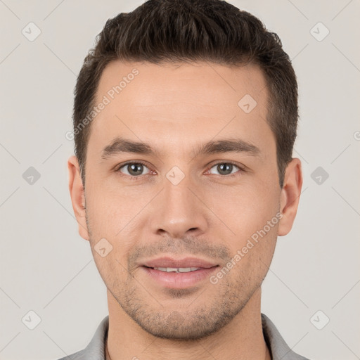 Joyful white young-adult male with short  brown hair and brown eyes