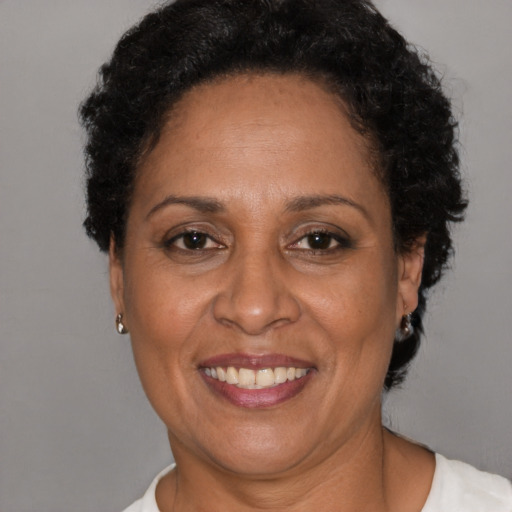 Joyful latino adult female with short  brown hair and brown eyes
