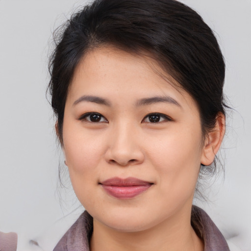 Joyful asian young-adult female with medium  brown hair and brown eyes