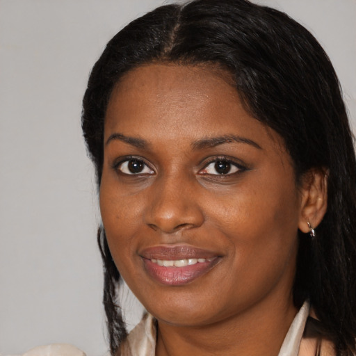 Joyful black young-adult female with medium  brown hair and brown eyes