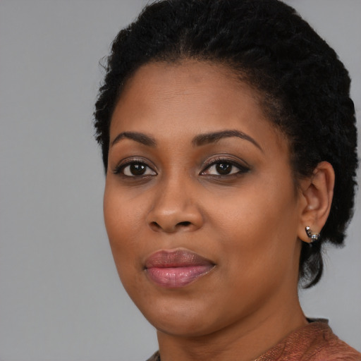 Joyful black young-adult female with medium  black hair and brown eyes