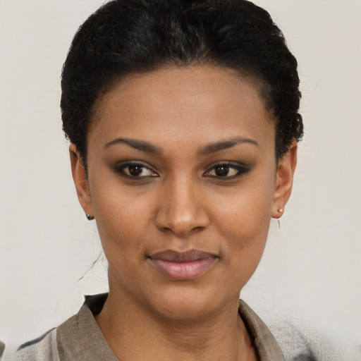 Joyful latino young-adult female with short  brown hair and brown eyes