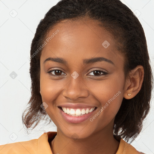 Joyful black young-adult female with long  brown hair and brown eyes