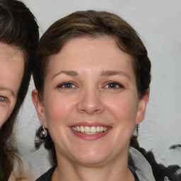 Joyful white young-adult female with medium  brown hair and blue eyes