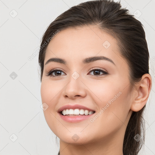 Joyful white young-adult female with long  brown hair and brown eyes