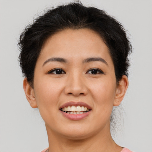 Joyful asian young-adult female with short  brown hair and brown eyes