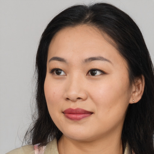 Joyful asian young-adult female with medium  brown hair and brown eyes