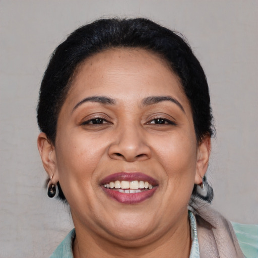 Joyful latino adult female with short  brown hair and brown eyes