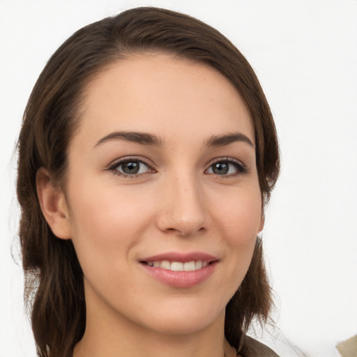 Joyful white young-adult female with long  brown hair and grey eyes