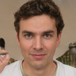 Joyful white adult male with short  brown hair and brown eyes