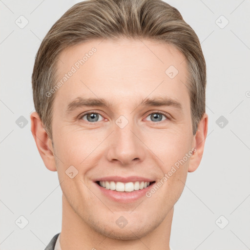 Joyful white young-adult male with short  brown hair and grey eyes