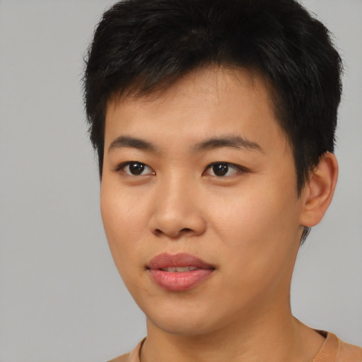 Joyful asian young-adult male with short  brown hair and brown eyes