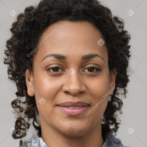 Joyful black adult female with medium  brown hair and brown eyes