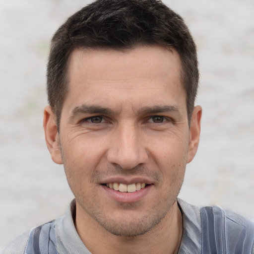 Joyful white adult male with short  brown hair and brown eyes