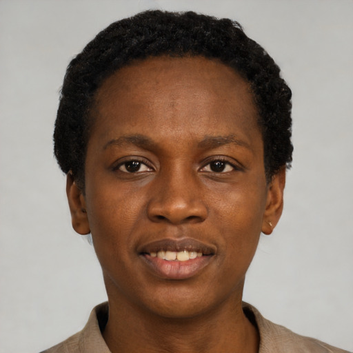 Joyful black young-adult female with short  black hair and brown eyes