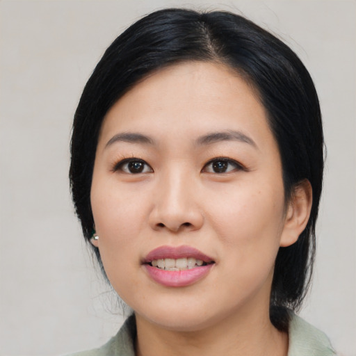 Joyful asian young-adult female with medium  black hair and brown eyes