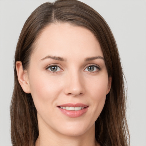 Joyful white young-adult female with long  brown hair and grey eyes