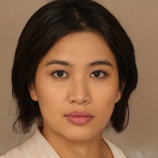 Neutral asian young-adult female with medium  brown hair and brown eyes