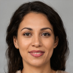 Joyful latino young-adult female with medium  brown hair and brown eyes