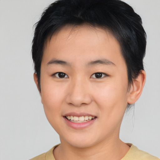 Joyful asian young-adult female with short  brown hair and brown eyes