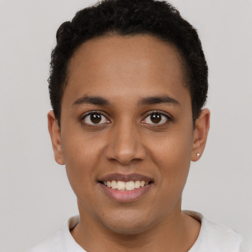 Joyful latino young-adult female with short  brown hair and brown eyes