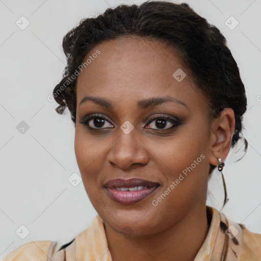 Joyful black young-adult female with long  brown hair and brown eyes