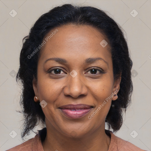 Joyful black adult female with medium  brown hair and brown eyes