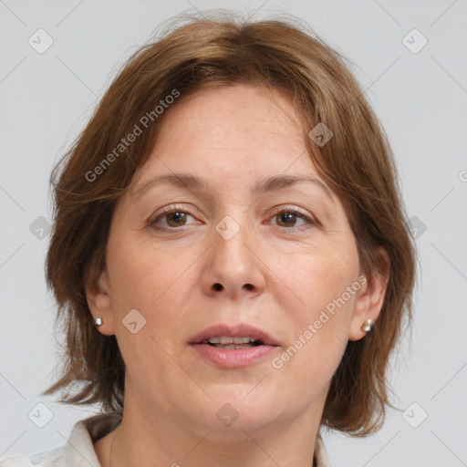 Joyful white adult female with medium  brown hair and grey eyes