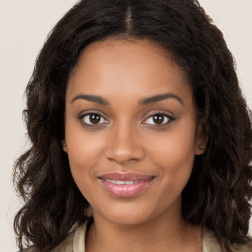 Joyful black young-adult female with long  brown hair and brown eyes