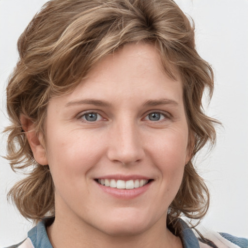 Joyful white young-adult female with medium  brown hair and blue eyes