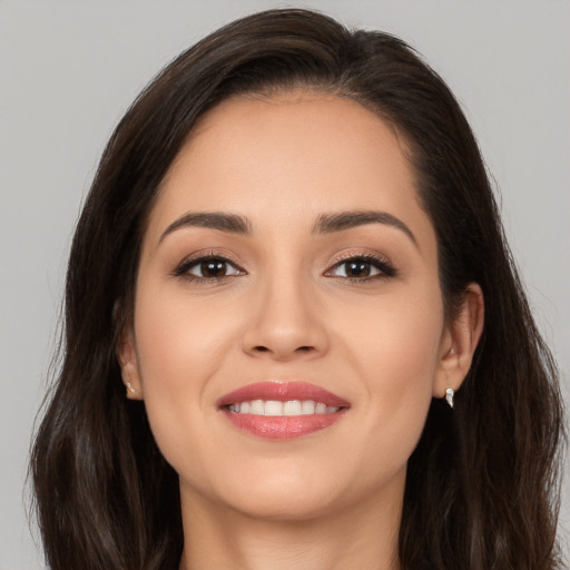 Joyful white young-adult female with long  brown hair and brown eyes