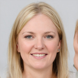 Joyful white young-adult female with medium  brown hair and blue eyes