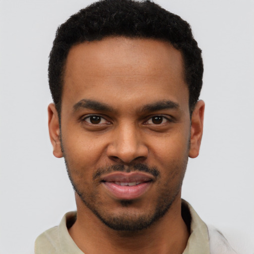 Joyful black young-adult male with short  black hair and brown eyes