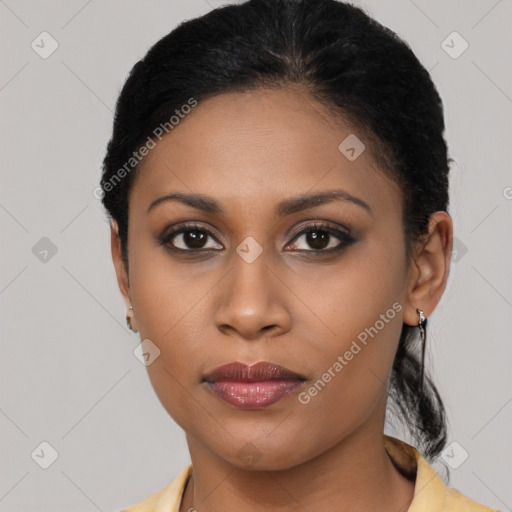 Joyful black young-adult female with short  black hair and brown eyes