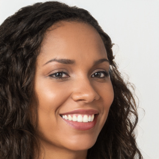 Joyful latino young-adult female with long  brown hair and brown eyes