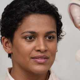 Joyful black young-adult female with short  brown hair and brown eyes