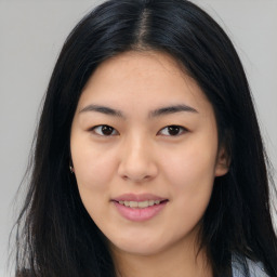 Joyful asian young-adult female with long  black hair and brown eyes