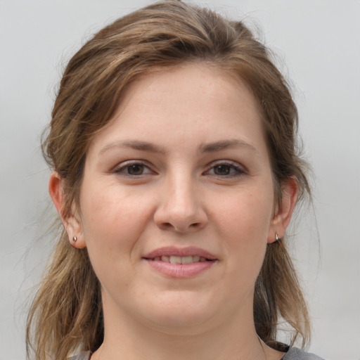 Joyful white young-adult female with medium  brown hair and grey eyes