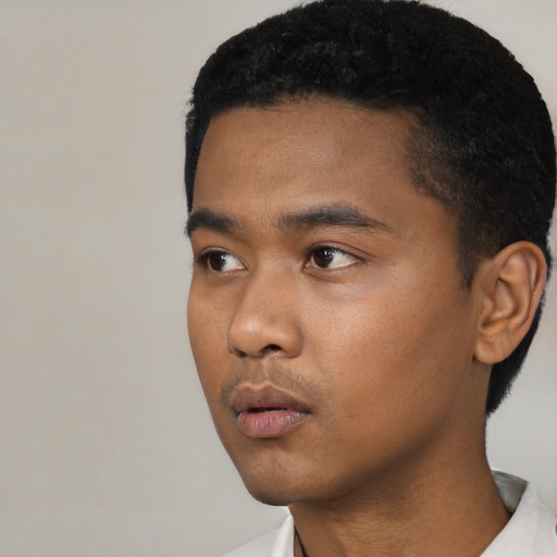 Neutral black young-adult male with short  black hair and brown eyes
