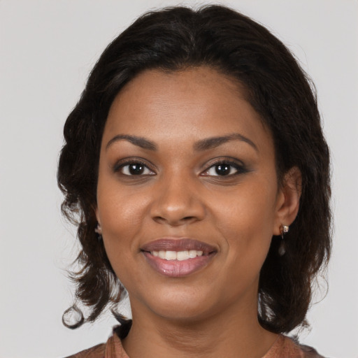 Joyful black young-adult female with medium  brown hair and brown eyes